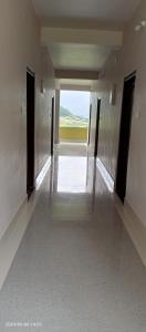a hallway in a building with a view of a field at Valley View Homestay in Dirang Dzong
