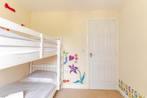 a bedroom with two bunk beds and a ladder at 4 Bedroom Detached, Wi-Fi, Parking, stunning views in Newcastle under Lyme