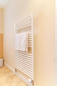 a bathroom with a towel hanging on a towel rack at 4 Bedroom Detached, Wi-Fi, Parking, stunning views in Newcastle under Lyme