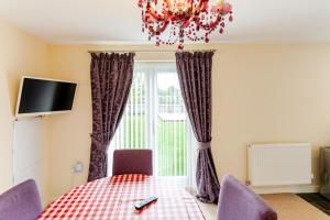 a dining room with a table and a window at 4 Bedroom Detached, Wi-Fi, Parking, stunning views in Newcastle under Lyme