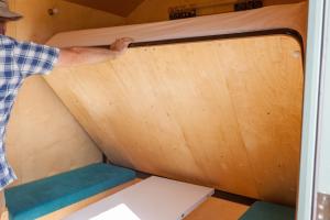 a man is standing in a tiny house at Barbara Shepherds Hut in Kent