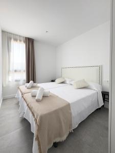 Postel nebo postele na pokoji v ubytování Apartamentos Clotilde