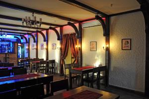 a dining room with tables and chairs in a restaurant at Casablanca Hotel in Kalush