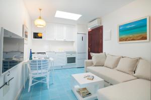 a living room with a couch and a table at Sea Front Caletón Suite in Los Pocillos
