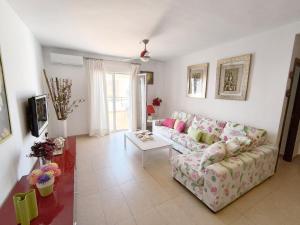 a living room with a couch and a table at Casa Cati in La Herradura