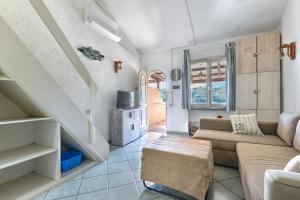 a living room with a couch and a table at Mono4Posti Vista Mare Il Portolano in Porto Azzurro