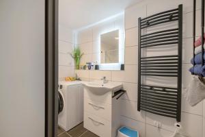 a bathroom with a sink and a washing machine at Neue 4 Zi Küche Bad Parknähe in Neunkirchen +16 photos