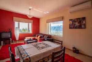 a living room with a table and a couch at Cozy Hilltop Home with Breathtaking Views in Magoúla