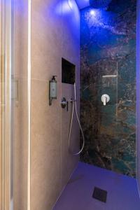 a bathroom with a shower with a glass door at Trevi Monti House in Rome
