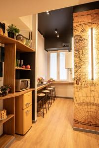 a kitchen with a large map on the wall at Trevi Monti House in Rome +24 photos
