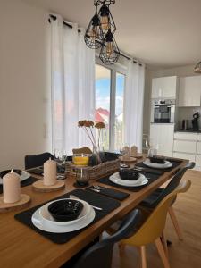 a dining room table with plates and glasses on it at AMAO-Sepia - Spacious Family Apartment - 6 Guests - Parking in Rheinhausen