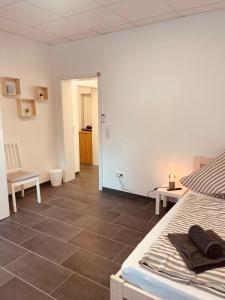 a bedroom with a bed and a tile floor at Cityapartment in Stadtlohn