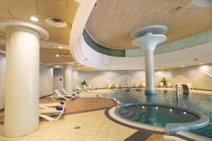a pool in a hotel lobby with a swimming pool at R2 Hotel Pajara Beach in Costa Calma
