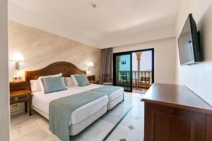 a hotel room with a bed and a television at R2 Rio Calma in Costa Calma