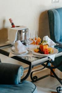 a table with a plate of fruit and wine glasses at R2 Rio Calma in Costa Calma
