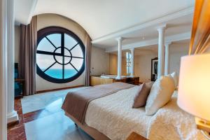 a bedroom with a large bed and a large window at R2 Rio Calma in Costa Calma