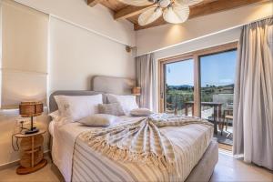 a bedroom with a bed and a large window at White Stone Villa Orion - Poolside Escape Close to Laganas Beach in Lithakia +22 photos