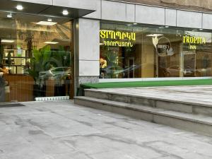 a store front of a building with steps in front at Tropica Inn Hotel in Yerevan