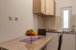 a bowl of fruit on a counter in a kitchen at Apartments Nena ST - Standard One Bedroom Apartment with Balcony and Sea View A2 in Pisak +3 photos
