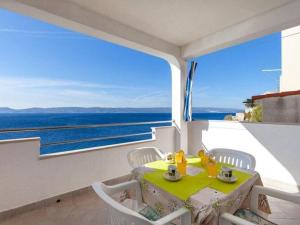 a table and chairs in a room with a view of the ocean at Apartments Nena ST - Standard One Bedroom Apartment with Balcony and Sea View A2 in Pisak