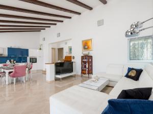a living room with a white couch and a table at Villa Dea - Luxury Villa with Outdoor Swimming Pool in Vučevica