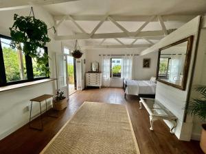 a living room with a bed and a couch at Urban Plett in Plettenberg Bay