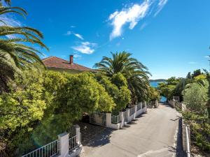 a street in front of a house with trees at Holiday Home Lido - Three Bedroom Holiday House with Terrace in Orebić