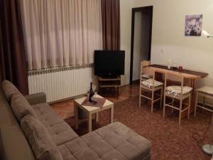 a living room with a couch and a table at Apartments & Rooms Renduli - One Bedroom Apartment with Balcony in Rakovica