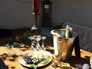 a wooden table with wine glasses and a bucket on it at Apartments Villa Dona -Two Bedroom Apartment with Shared Swimming Pool in Vela Luka