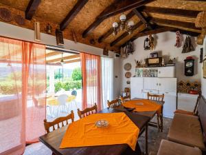 a dining room with two tables and a kitchen at Apartment Laurel Leaf - Three Bedroom Apartment with Terrace in Gruda