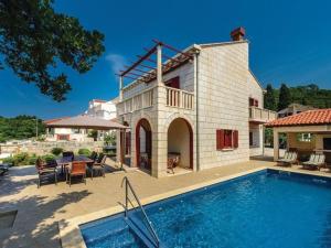 a house with a swimming pool in front of a house at Villa Anka - Five-Bedroom Villa with Terrace and Swimming Pool in Zaton