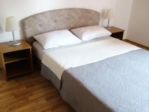 a bedroom with a large bed and two night stands at Guesthouse afran- Two Bedroom Apartment in Plitvička Jezera