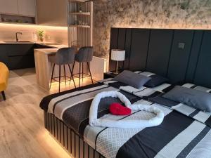 a bedroom with two beds with towels and a kitchen at Wellness Apartments - Studio Apartment with Terrace G3 in Varaždin
