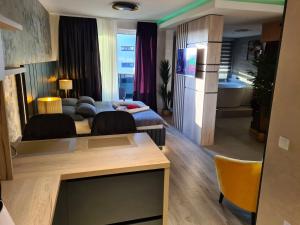 a living room with a couch and a kitchen at Wellness Apartments - Studio Apartment with Terrace G3 in Varaždin +8 photos