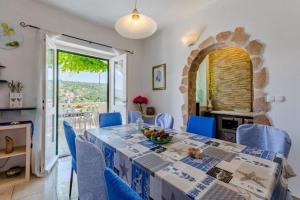 a dining room with a table and blue chairs at Apartment Blue Oasis - Three Bedroom Apartment ST in Postira