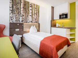 Posteľ alebo postele v izbe v ubytovaní Eco Suite Hotel