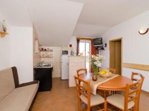 a kitchen and dining room with a table and chairs at Apartments Senjo - One Bedroom Apartment with Balcony with Sea View Apartman 1 in Cavtat