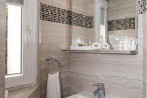 a bathroom with a sink and a bath tub at Mali Skoj Apartment - Two-Bedroom Apartment with Sea View in Suđurađ +26 photos