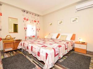 a bedroom with a large bed and a window at Holiday Home Belmondo- Three Bedroom Home with Terrace and Private Pool A6 in Gruda +18 photos