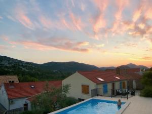 a woman standing in a swimming pool in a house at Holiday Home Stari Zoganj - Two Bedroom Holiday Home with Terrace and Swimming Pool in Potomje