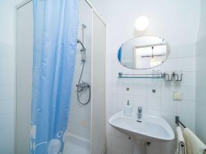 a bathroom with a sink and a shower with a mirror at Apartments Zarac - One Bedroom Apartment with Balcony and Sea View Milanka in Zaton +29 photos