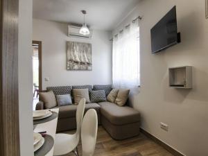 a living room with a couch and a table at Apartments Victoria - One Bedroom Apartment with Terrace A2 in Pakoštane