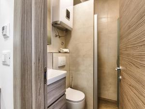 a small bathroom with a toilet and a sink at Apartments Victoria - One Bedroom Apartment with Terrace A2 in Pakoštane +13 photos