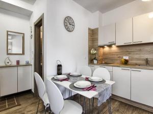 a kitchen and dining room with a table and chairs at Apartments Victoria - One Bedroom Apartment with Terrace A2 in Pakoštane
