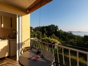 a table on a balcony with a view of the ocean at Apartments Belenum - Comfort Double Room with Balcony and Sea View no 1 in Mlini +10 photos
