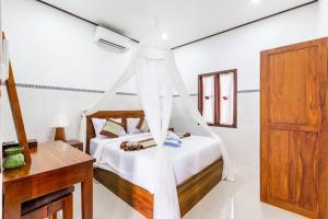 a bedroom with a bed with a mosquito net at Kubu Kapas Bali in Ubud +63 photos