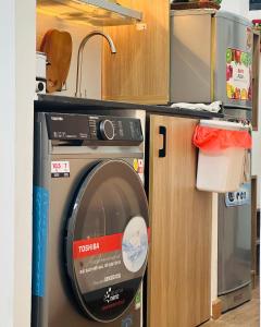 a washing machine in a kitchen next to a sink at Tom's Homestay in Ho Chi Minh City +104 photos