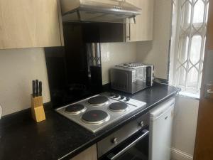 a kitchen with a stove and a microwave on a counter at Levy Nook 5 in Darlington