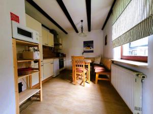 a small kitchen with a table and chairs in it at Feriendorf Hohen Bogen Haus 7 EG in Arrach