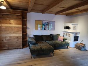 a living room with a couch and a fireplace at Casa Hochberg in Siegsdorf